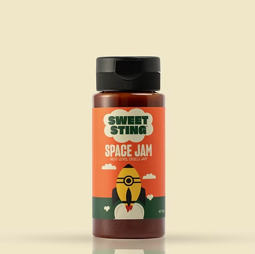 Bottle of Sweet Sting Space Jam chili jam on a beige background